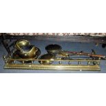 A BRASS FIRE FENDER and a collection of late 19th century brassware including warming pans