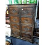 AN OAK AND PINE TWO DOOR CUPBOARD with carved decoration, the doors made from earlier oak panelling,