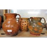 A COUNTRY POTTERY DRAINER with all over glaze and twin handles and two all over glazed pottery jugs