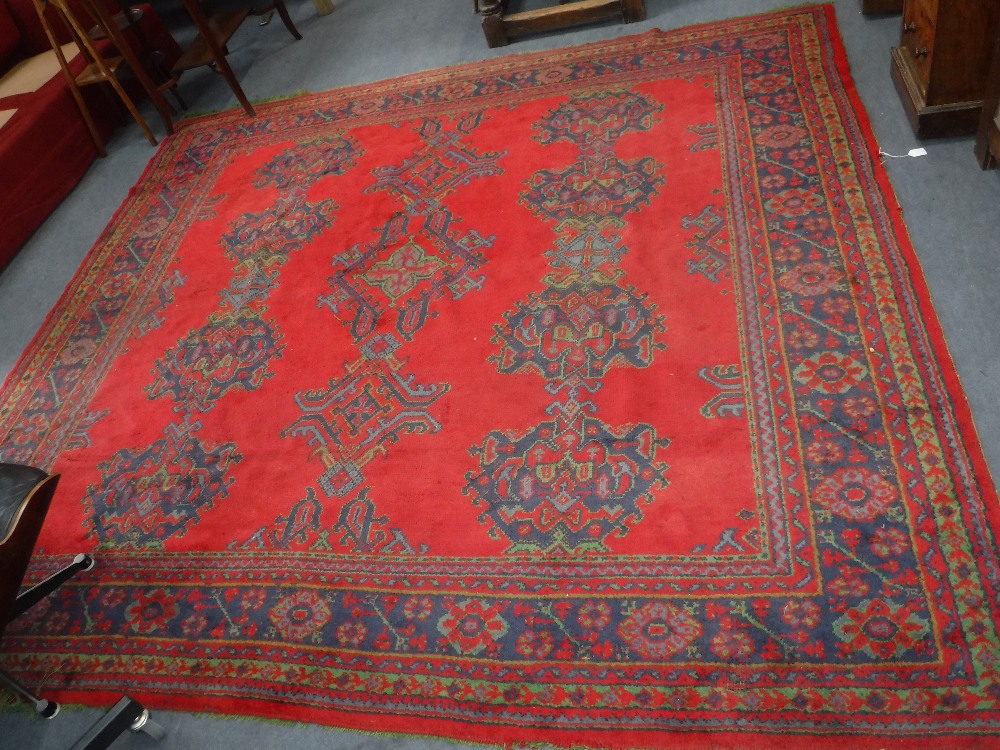 A LARGE 19TH CENTURY RED GROUND TURKEY CARPET, 101" x 112"