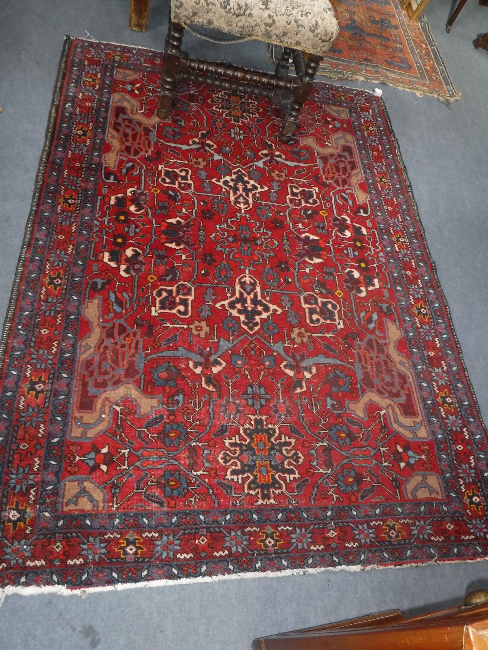 A RED GROUND PERSIAN RUG, 56" X 80"