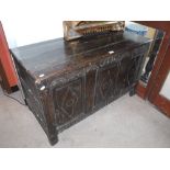 AN 18TH CENTURY OAK COFFER with incised fielded panels and carved date '1731' (later top) 43" wide