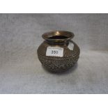 AN INDIAN WHITE METAL POT with embossed decoration, 4" high