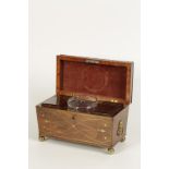 A REGENCY ROSEWOOD SARCOPHAGUS FORM BRASS INLAY TEA CADDY, the raised lid with central brass