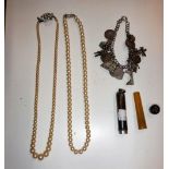 A STERLING SILVER CHARM BRACELET and a cheroot holder in a sterling silver case and two pearl