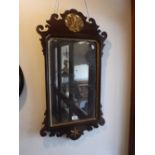 A GEORGE III WALNUT FRAMED WALL MIRROR with gilt decoration, 32.5" high