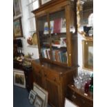 A 1930S OAK BOOKCASE, with glazed upper section, fitted drawers and cupboard doors below, 81" high x