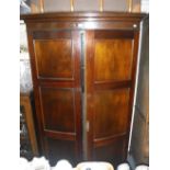 A MAHOGANY BOWFRONTED WARDROBE with panelled doors, 43" wide