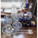 A BLUE GLASS DECANTER, with six glasses, overlaid with gilt decoration and similar glassware