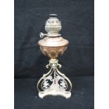 A VICTORIAN OIL LAMP, with a brass base and copper reservoir