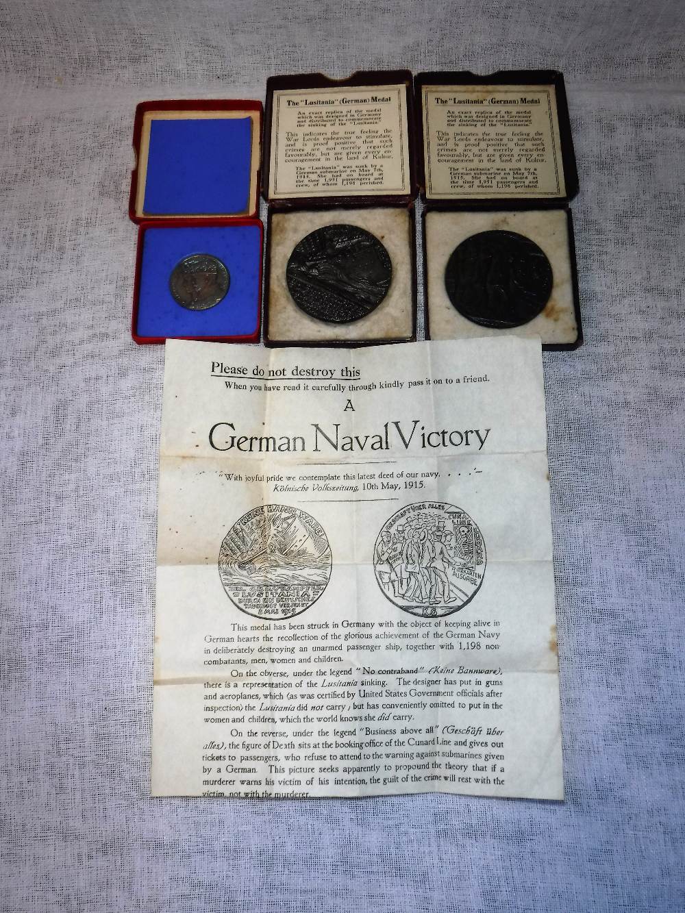 TWO RMS LUSITANIA MEDALS in original card boxes and a 1935 silver jubilee medal in original card