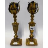 A PAIR OF VICTORIAN BRASS CANDLESTICKS with foliate motif to the top