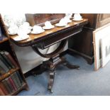 A REGENCY ROSEWOOD FOLD OVER TOP CARD TABLE, on four swept down feet with brass castors, 36" wide