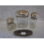 THREE SILVER MOUNTED CUT-GLASS BOTTLES and a silver nail buffer (4)