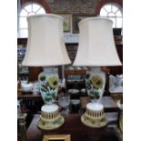 A PAIR OF TABLE LAMPS, with glass vase centres decorated with sunflowers, with shades, 30" high (inc