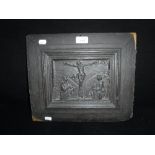 A CARVED WOODEN PANEL depicting The Crucified Christ, with The Virgin ant St John, 12" high