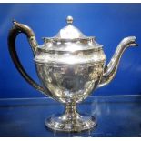 A GEORGE III SILVER PLATED COFFEE POT of neoclassical design, with laurel wreath cartouche