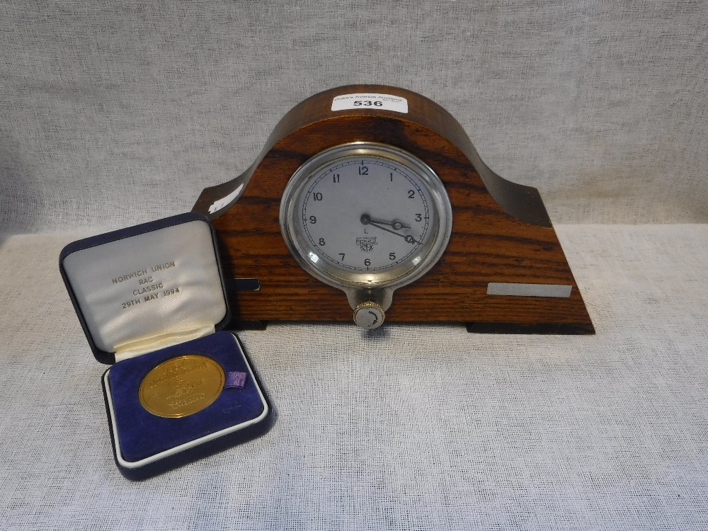 A NORWICH UNION MEDAL and a vintage 1930's Smith's Car Clock, contained in a wooden frame (2)