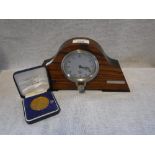A NORWICH UNION MEDAL and a vintage 1930's Smith's Car Clock, contained in a wooden frame (2)