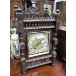 A VICTORIAN MANTEL CLOCK in an Aesthetic walnut case, 14.5" high (running, key in office)