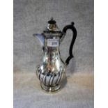 A VICTORIAN SILVER COFFEE POT with a scrolled ebony handle, Chester, 1896, 22cms high