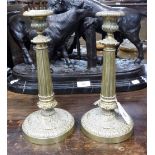 A PAIR OF 19TH CENTURY BRASS CANDLESTICKS with reeded columns, 9.5" high