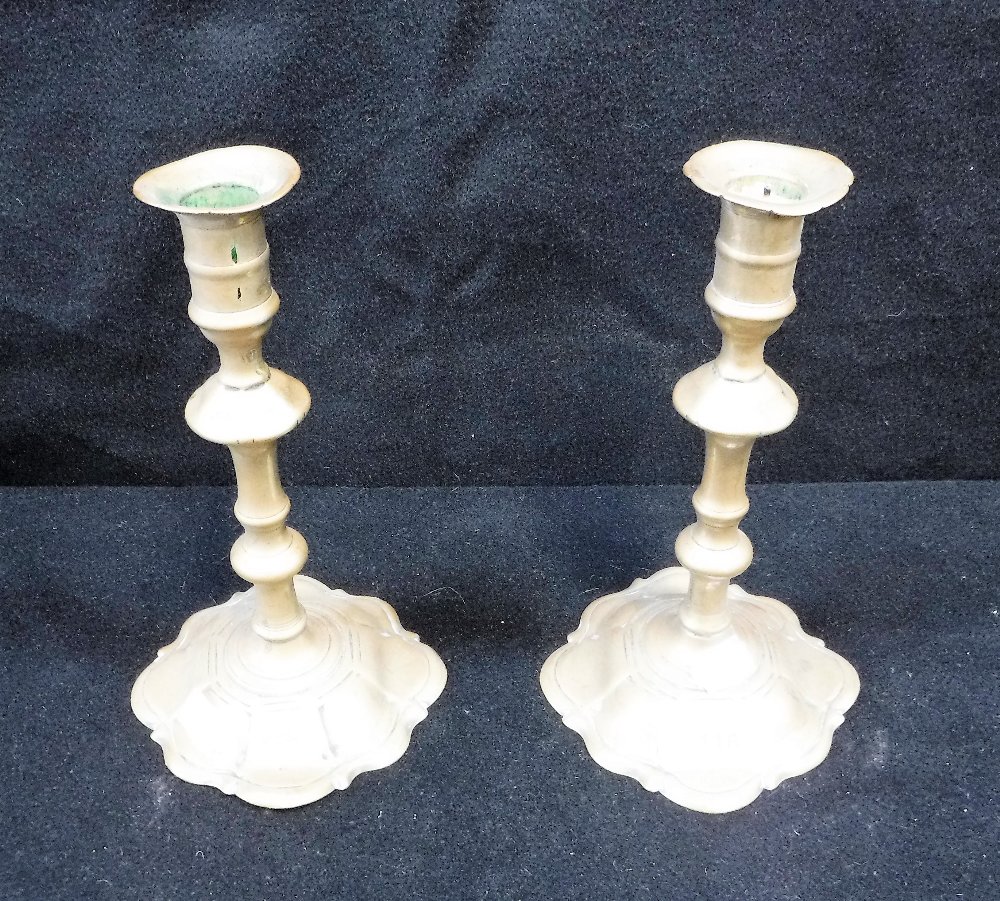 A PAIR OF 18TH CENTURY BRASS CANDLESTICKS, on lobed bases, 8'' high