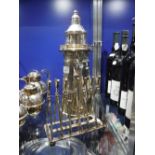 A REPRODUCTION PLATED COCKTAIL SHAKER in the form of a lighthouse and a similar toast rack formed