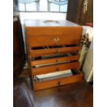 A VINTAGE MAHOGANY CASE, the drawers containing old dentistry equipment