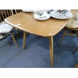 ERCOL; A PALE ELM DINING TABLE of rectangular form, on beech legs, 29" wide x 59" long