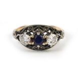 Unmarked gold sapphire and diamond ring, set with two diamonds either side of a centeral saphire and
