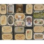 Oak framed display of World War I postcards, mostly silk examples together with a photographic