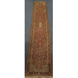 Large rectangular Persian Kerman carpet runner, the central field and boarders decorated all over