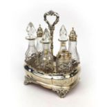 Early Victorian silver seven bottle cruet stand housing six glass bottles, three with silver lids,