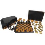 Piano shaped games compendium housing treen whist markers, chess/draught pieces and bone dominoes,