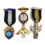 Group of three Masonic silver jewels, comprising two silver gilt and enamel examples and a cross