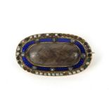 Victorian gold coloured metal mourning brooch set with a central lock of hair surrounded by