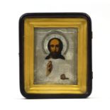 Hand painted Russian religious icon with relief silver plated mounts, housed in a glazed case,