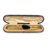 Silver gilt spectacle case with velvet lined interior and engraved floral decoration on a chatelaine