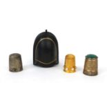 Three thimbles comprising a gold coloured metal example set with six pearls housed in a Victorian