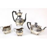 Walker & Hall silver four piece tea and coffee service with embossed decoration and raised on ball