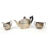 Silver three piece tea service, the teapot with ebonised wood handle and knop, G.H Sheffield 1928,