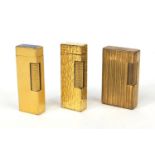 Group of three gold plated lighters, comprising two Dunhill examples and a Dupont example, the