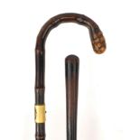 Two wooden walking sticks including a bamboo example with gilt collar, the longest 91cm long : For