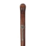 Tribal interest exotic wood walking stick with stylised silvered inlay possibly from New Zealand,