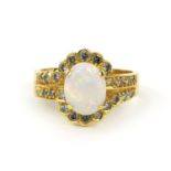 18ct gold opal and diamond ring set with a opal surrounded by twenty four diamonds, size R,