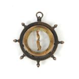 Victorian silver coloured metal compass pendant in the form of a ships wheel, with greyhound