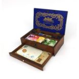 Winsor & Newton Mahogany artists box housing paints and a ceramic palette, 7cm high x 21.5cm wide