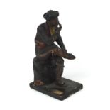 19th century Spanish polychrome painted terracotta figure of a seated pipe smoking gentleman,