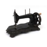 Victorian cast iron mechanical sewing machine, numbered 285154 108154, 21cm high x 42cm in length